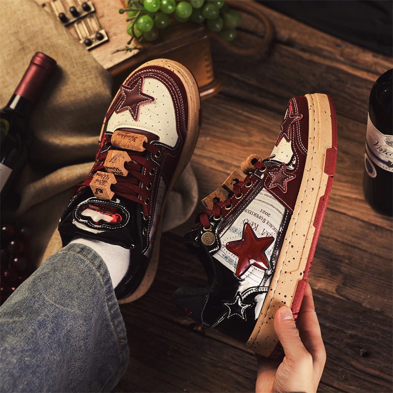 Person holding a pair of decorative sneakers with star and cork design on a wooden surface.
