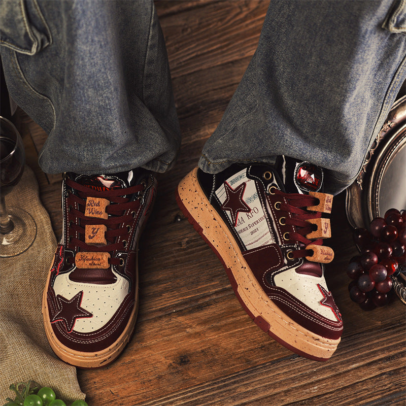 Pair of high-top sneakers with star design worn by a person on a wooden floor.